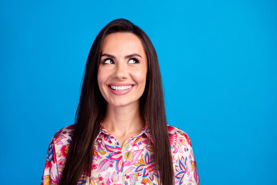 Photo of dreamy toothy lady dressed print blouse looking empty space isolated blue color background