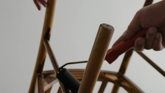 Restoration of a wooden chair. Covering with dark varnish. Close-up. Vintage things. High quality 4k footage