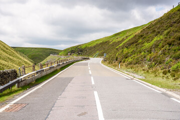 Deserted mountain pass road in England on a cloudy summer day