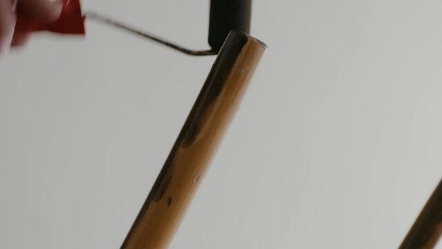 Restoration of a wooden chair. Covering with dark varnish. Close-up. Vintage things. High quality 4k footage