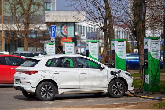 Minsk, Belarus. Mar 31, 2024. White BYD E2 at charge station. Parked compact electrical city car charge battery at power station in the city. Ev car charging.