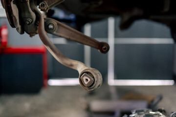 close-up of rusty brake pad on a metal wheel holder at a service station