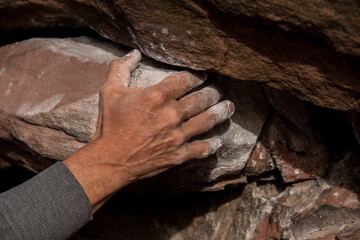 Magnesium-filled venous hands of a climber while scaling a rock wall.