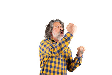 Expressive man celebrating while raising his arms and shouting