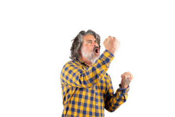 Expressive man celebrating while raising his arms and shouting