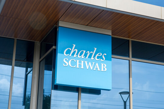Houston, Texas, USA - April 7, 2024: Charles Schwab logo sign at one of their offices in Houston, Texas, USA. The Charles Schwab Corporation is an American multinational financial services company.