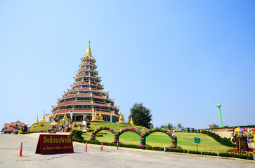 Big stupa chedi and chinese pagoda for thai people travelers travel visit respect praying blessing deity mystical in Wat Huay Pla Kang temple at Chiangrai on February 24, 2015 in Chiang Rai, Thailand