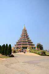 Big stupa chedi and chinese pagoda for thai people travelers travel visit respect praying blessing deity mystical in Wat Huay Pla Kang temple at Chiangrai on February 24, 2015 in Chiang Rai, Thailand