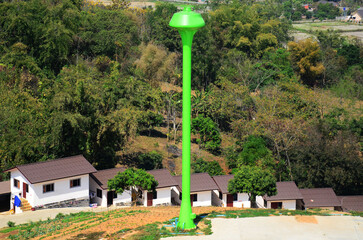 View landscape Rim Kok village country countryside on mountain hill with tower tank water artesian groundwater in aquifers of small village in outdoor park at Chiangrai rural in Chiang Rai, Thailand