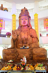 Carving wooden Quan Yin or wood Kuan Yin chinese goddess for thai people travelers travel visit respect praying wish blessing at Wat Huay Pla Kang temple on February 24, 2015 in Chiang Rai, Thailand