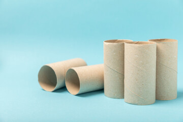 Empty toilet paper roll. Rolls of toilet paper on a blue background. Paper tube of toilet paper. Place for text. Copy space. Flat lay. Eco-friendly reuse recycle