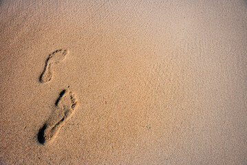 Fototapeta na wymiar Human footprints in the sand