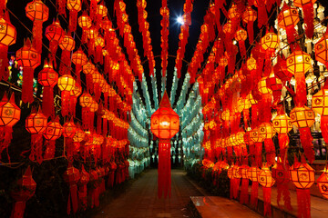 Colorful illuminated lantern tunnel at night during Loy Krathong festival in Thailand.