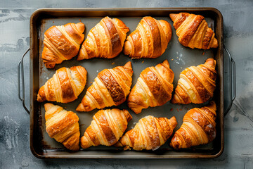 freshly baked croissants on baking pan - 781436136