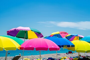 A beach scene with many colorful umbrellas. Scene is cheerful and lively, as the umbrellas are spread out across the beach, providing shade for the people enjoying the sunny day
