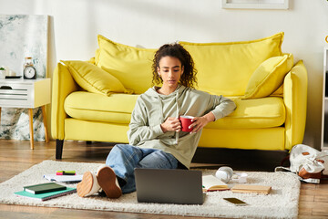 A teenage girl engrossed in e-learning at home, sitting on the floor working on her laptop.