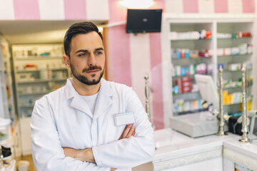 Portrait of male pharmacist at the modern pharmacy, drugstore. - obrazy, fototapety, plakaty