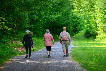 My wife, sister and brother-in-law walking on a nice stone path leading through the woods in PA. The husband is comfortable with his manhood and he is willing to wear his wife's pink backpack.