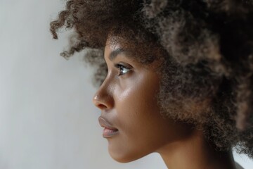 Profile image capturing the beauty and texture of a woman's voluminous curls against a soft background - Powered by Adobe