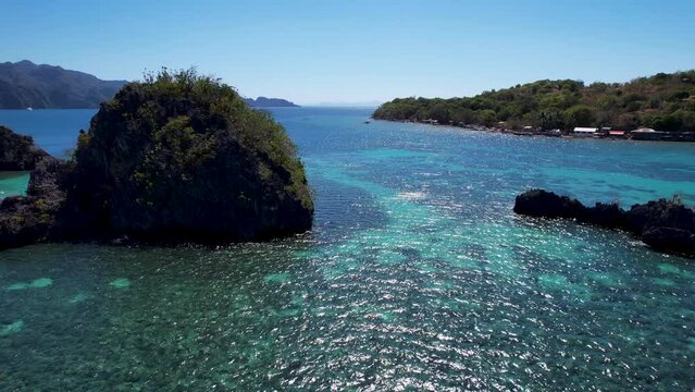 4K Aerial drone video of Siete Pecados Siete with boats surrounded by blue sea. Coron, Palawan. Philippines.