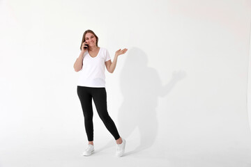 anned girl with a mobile phone on a white background. emotions and gestures. mockup