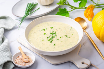 Spring white creamy zucchini soup with herbs
