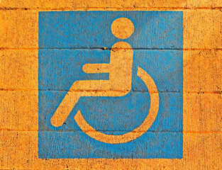 Wheelchair pictogram painted on sidewalk