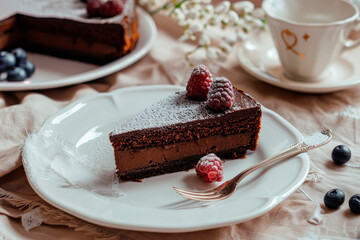 Tasty homemade slice chocolate cake with berries on dark background - 781451353
