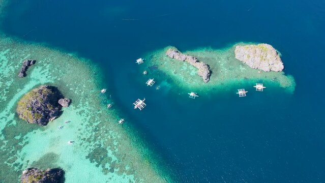 4K Aerial drone video of Siete Pecados Siete with boats surrounded by blue sea. Coron, Palawan. Philippines.