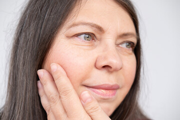 closeup face mature woman 55 years old, human fat neck, side view, double saggy chin, deep...
