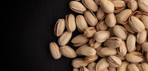 Pistachios on a black background with copy space