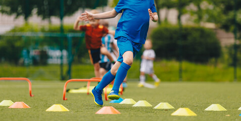 Outdoor Sports Activities for Kids. Children Running at Practice Field. Elementary-Age Children at Slalom Training Drill