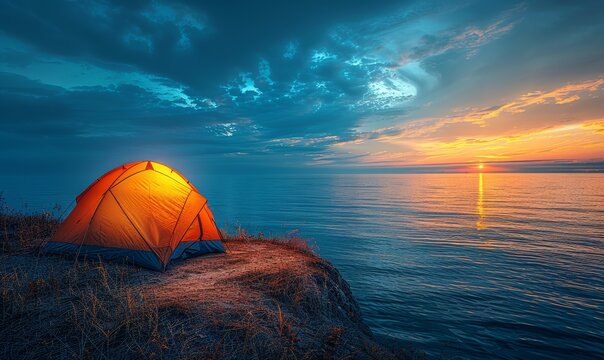 A small orange tent is set up on a rocky shoreline by the ocean