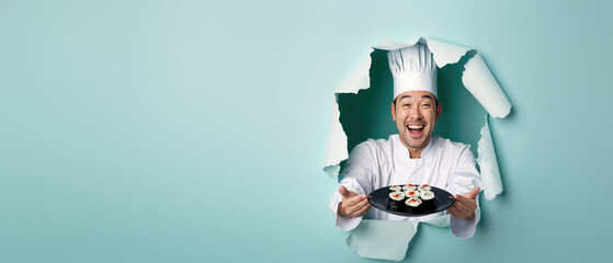 Excited chef in a white uniform offering sushi through a hole in a blue paper background