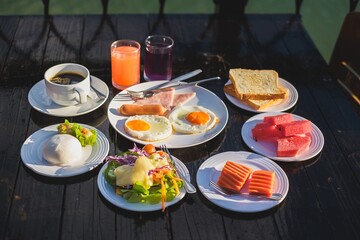 A restaurant table set with a delicious meal including fish, salad, and vegetables