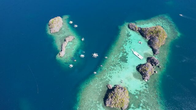 4K Aerial drone video of Siete Pecados Siete with boats surrounded by blue sea. Coron, Palawan. Philippines.