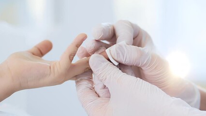 A doctor takes a patient's blood sample from a finger prick. Child's blood test. Blood test, blood group determination and medicine concept