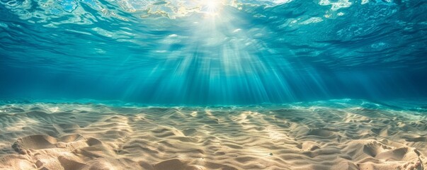 Serene underwater sunlight over sandy ocean floor - obrazy, fototapety, plakaty