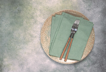 a plate with a kitchen towel and two forks, food wallpaper, food concept, top view, no people,