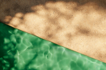 Top view of travertine poolside in luxury hotel villa with sunlight shadow and swimming pool. Summer tropical background for product placement podium mockup.