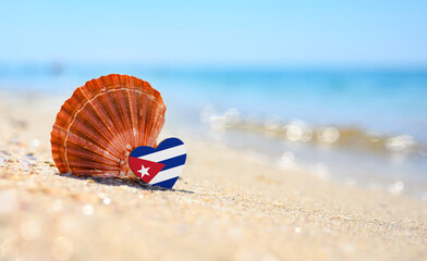 Sandy beach in Cuba. Cuba flag in the shape of a heart and a large shell. A wonderful resort on the...