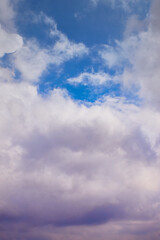 Transition of a cloud from white to rainy in the blue sky, vertical shot