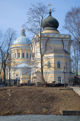 St. Nicholas Church in the background of the Trinity Cathedral on a sunny April day. Nikolsky Cemetery of the Alexander Nevsky Lavra, Saint Petersburg - 781495124