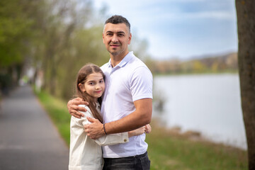 Father hugging daughter outdoors. family portrait