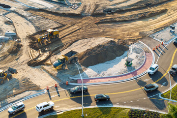 Roadworks construction site at roundabout intersection on American highway. Development of city...
