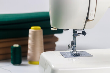 Photo of a needle with thread attached to a sewing machine.
