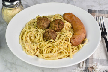 linguine in alfredo sauce  with meat balls and  italian  sausage