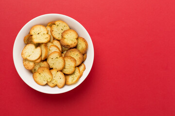 Spiced bruschette chips on color background, top view