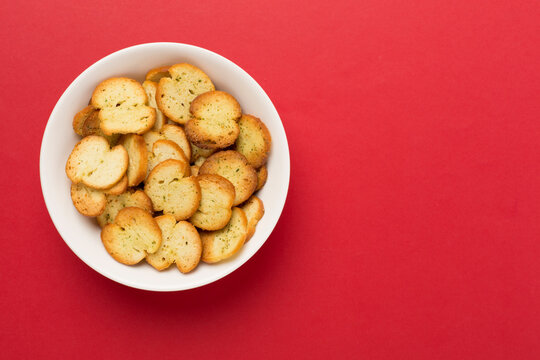 Spiced bruschette chips on color background, top view