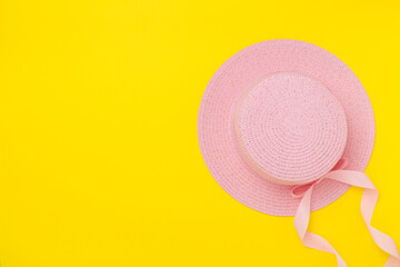 Pink hat on color background, top view. Summer concept